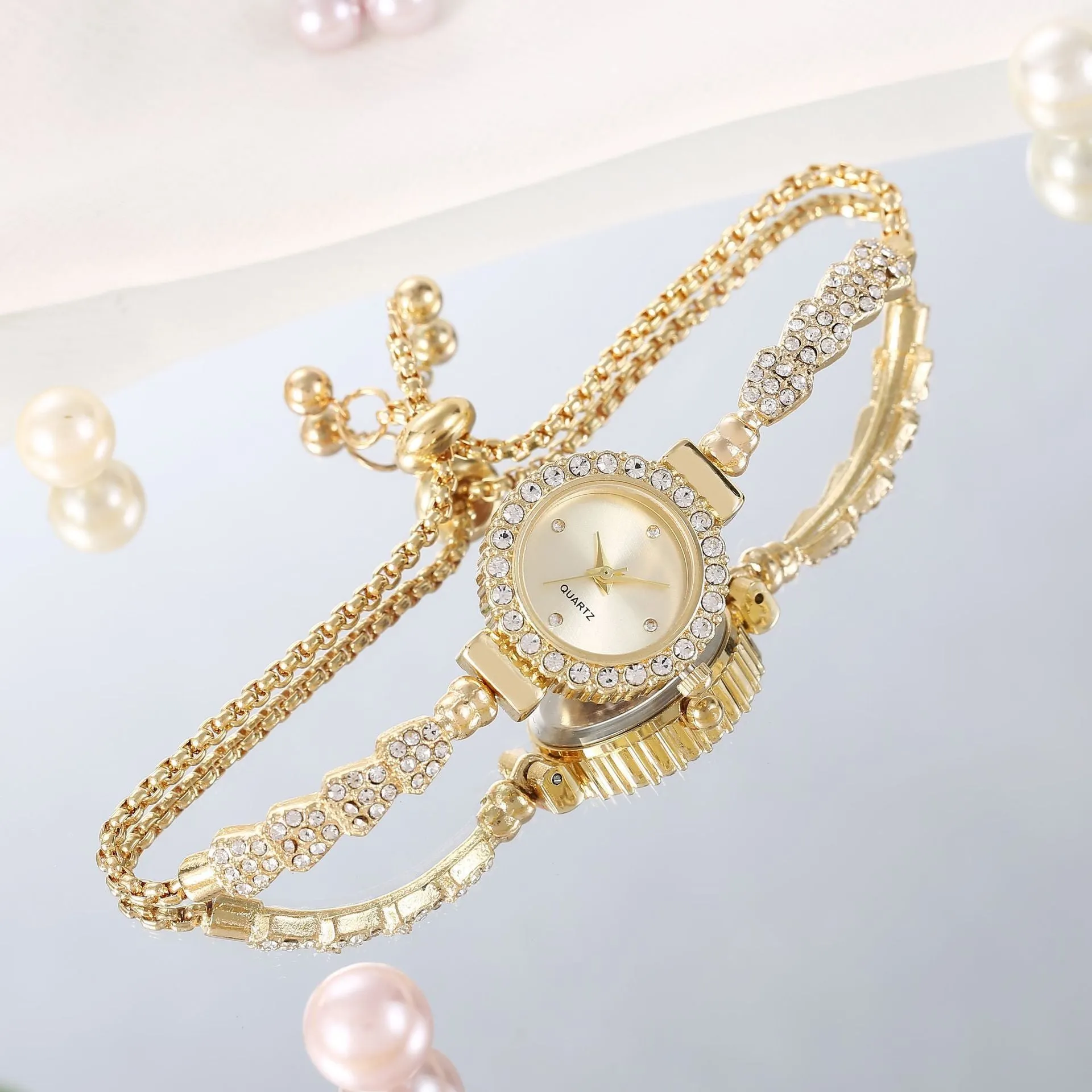 Gold fine strap women's watch with round dial and stainless steel jewellery buckle