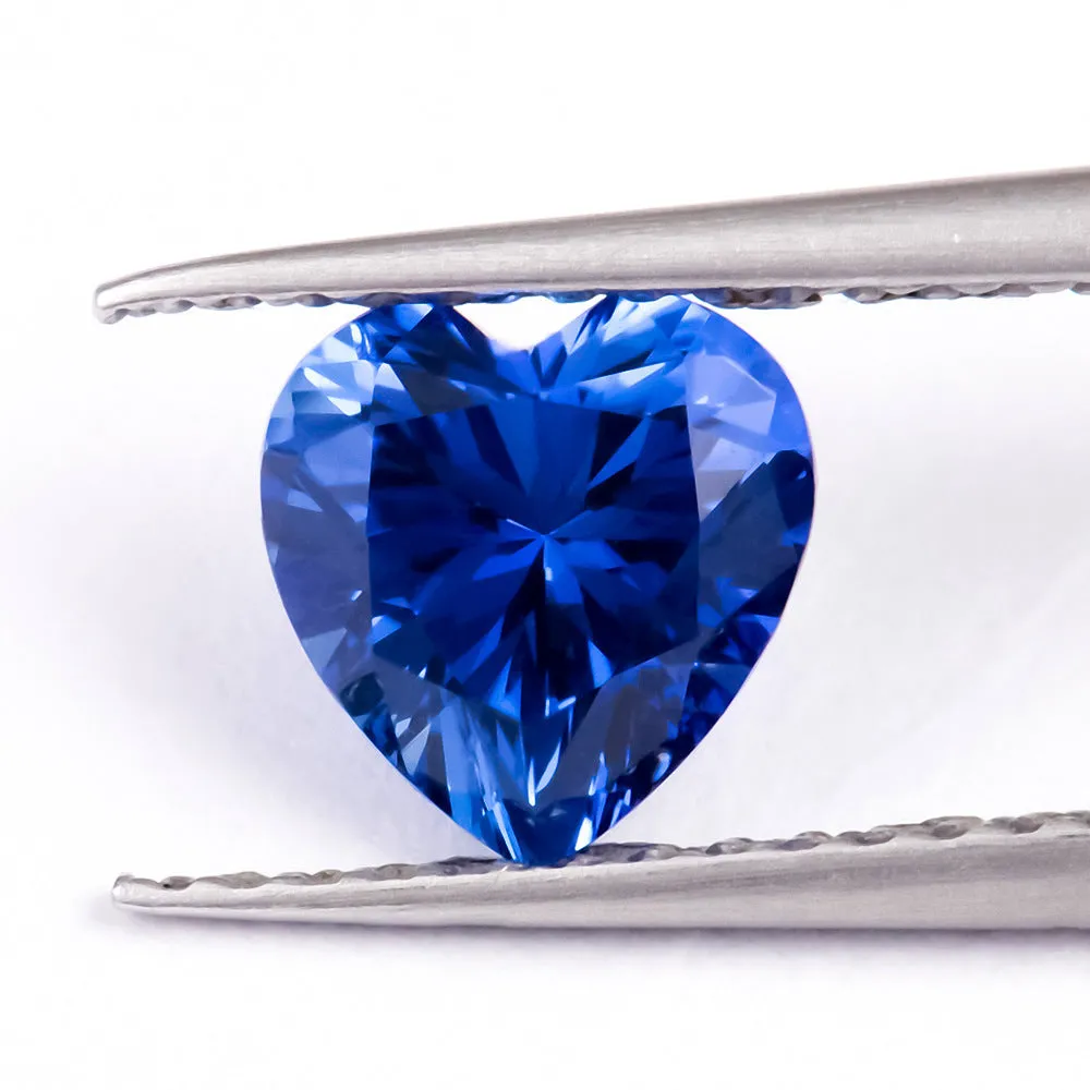 Royal blue heart shaped tiara gemstone jewellery component on white background.