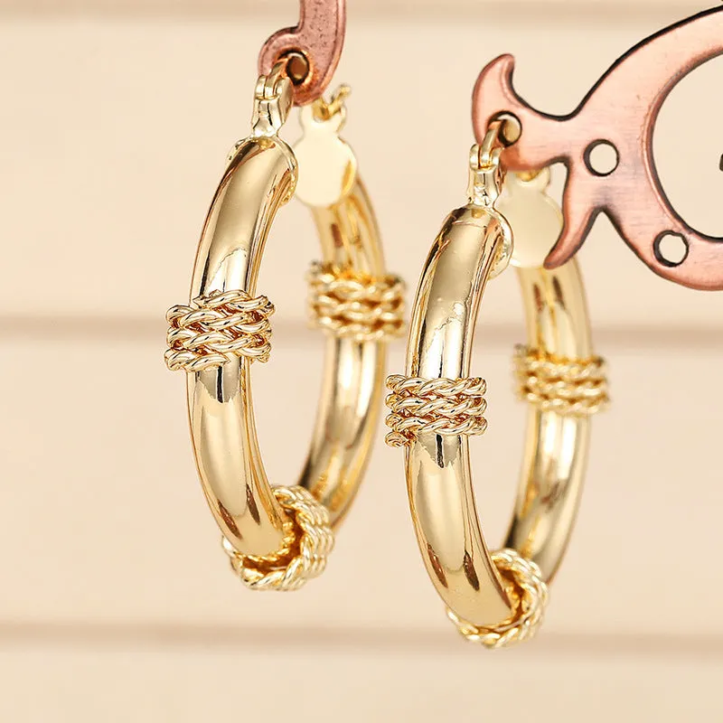 Geometric gold-coloured copper earrings with ring and line design elements