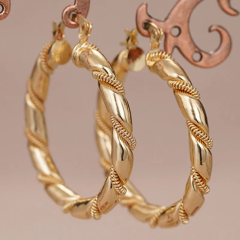 Geometric gold-coloured copper earrings with ring and line design elements