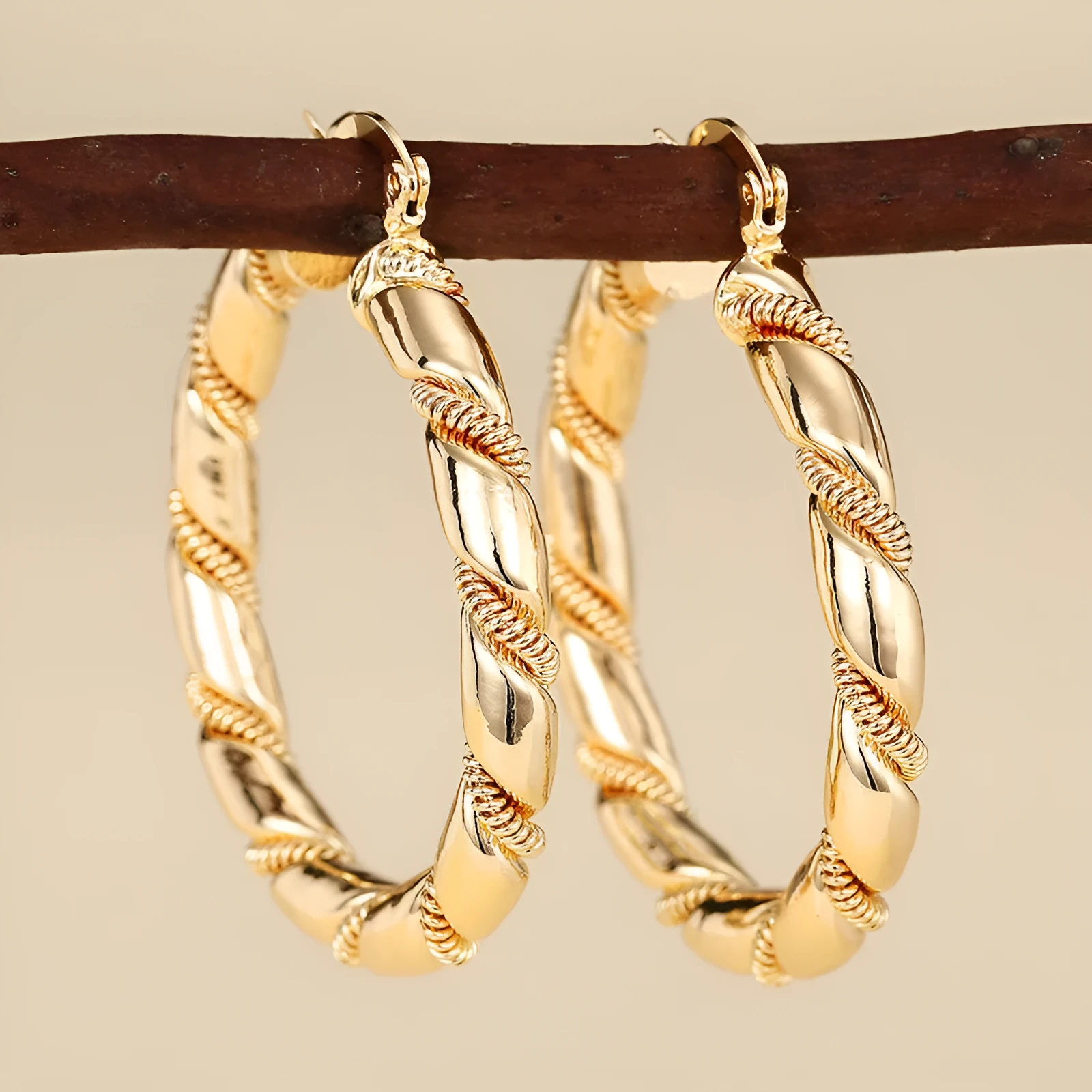 Geometric gold-coloured copper earrings with ring and line design elements