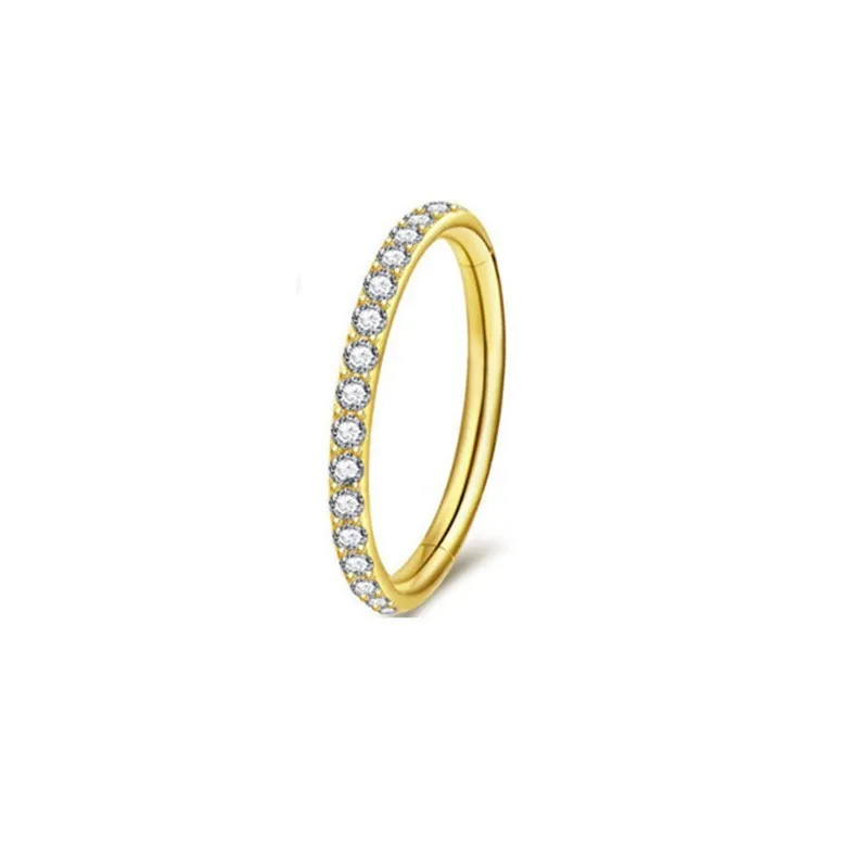 A round stainless steel seamless nose ring on a grey background, shown in a gold plated finish.