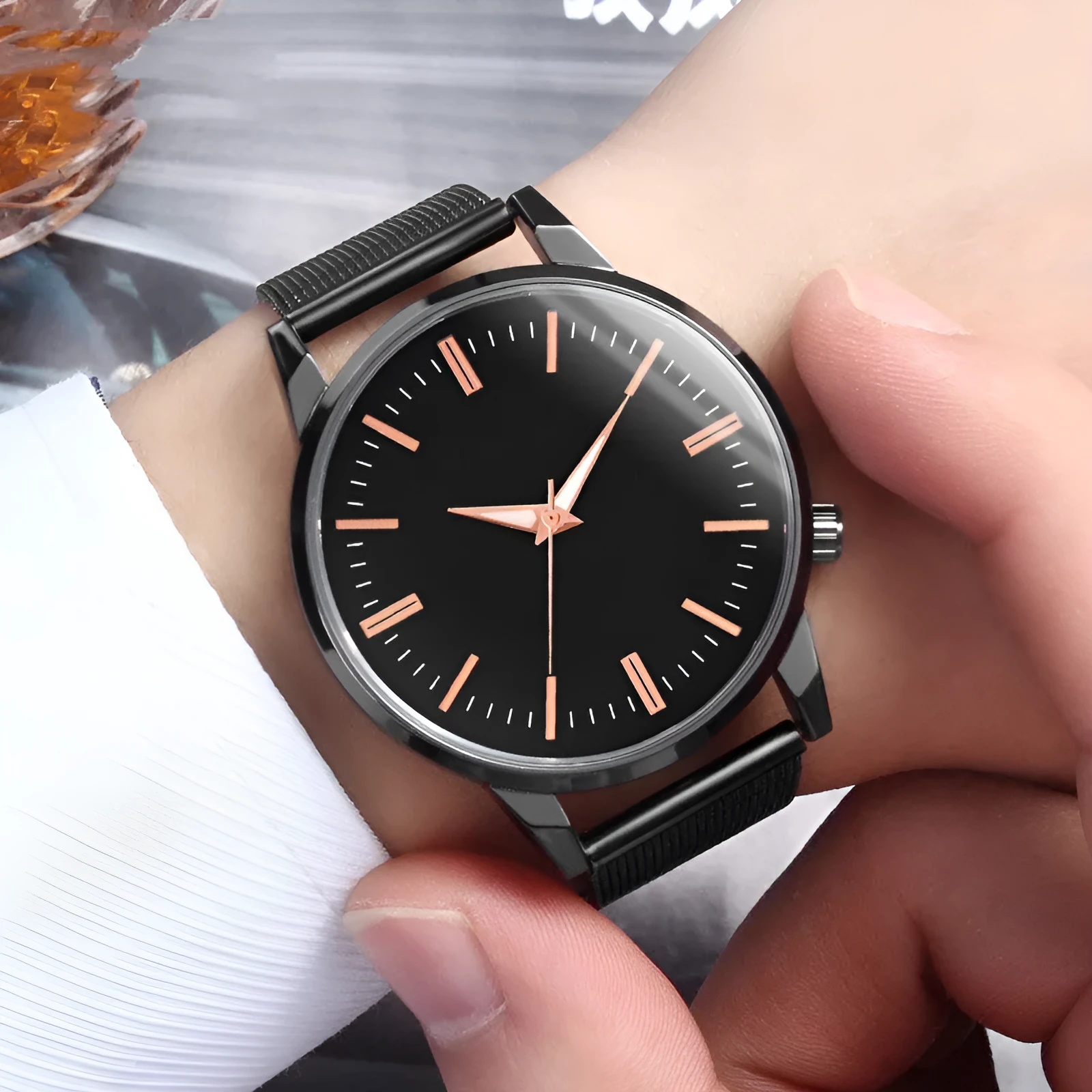 Men's and women's couple watch set with blue metal mesh band, luminous dial, and alloy case on a white background