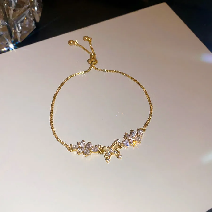 Flower butterfly pendant bracelet for women, copper inlaid zircon, gold finish on white background