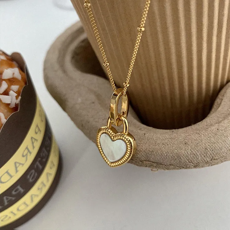 Double-sided shell love pendant necklace with mixed gem inlay on adjustable chain, available in gold-plated copper or titanium steel