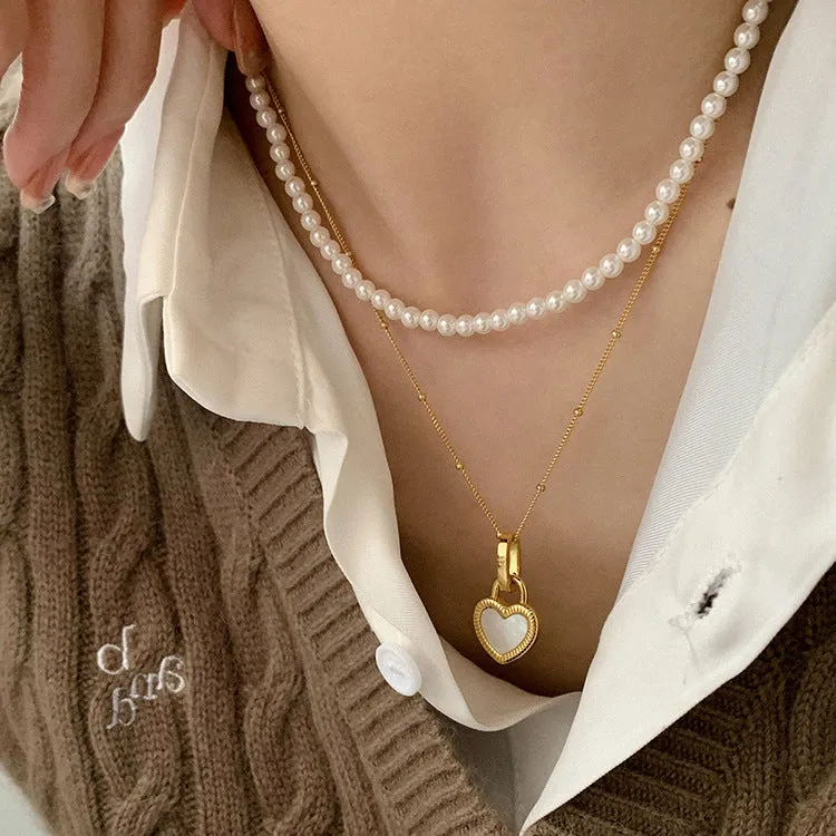 Double-sided shell love pendant necklace with mixed gem inlay on adjustable chain, available in gold-plated copper or titanium steel