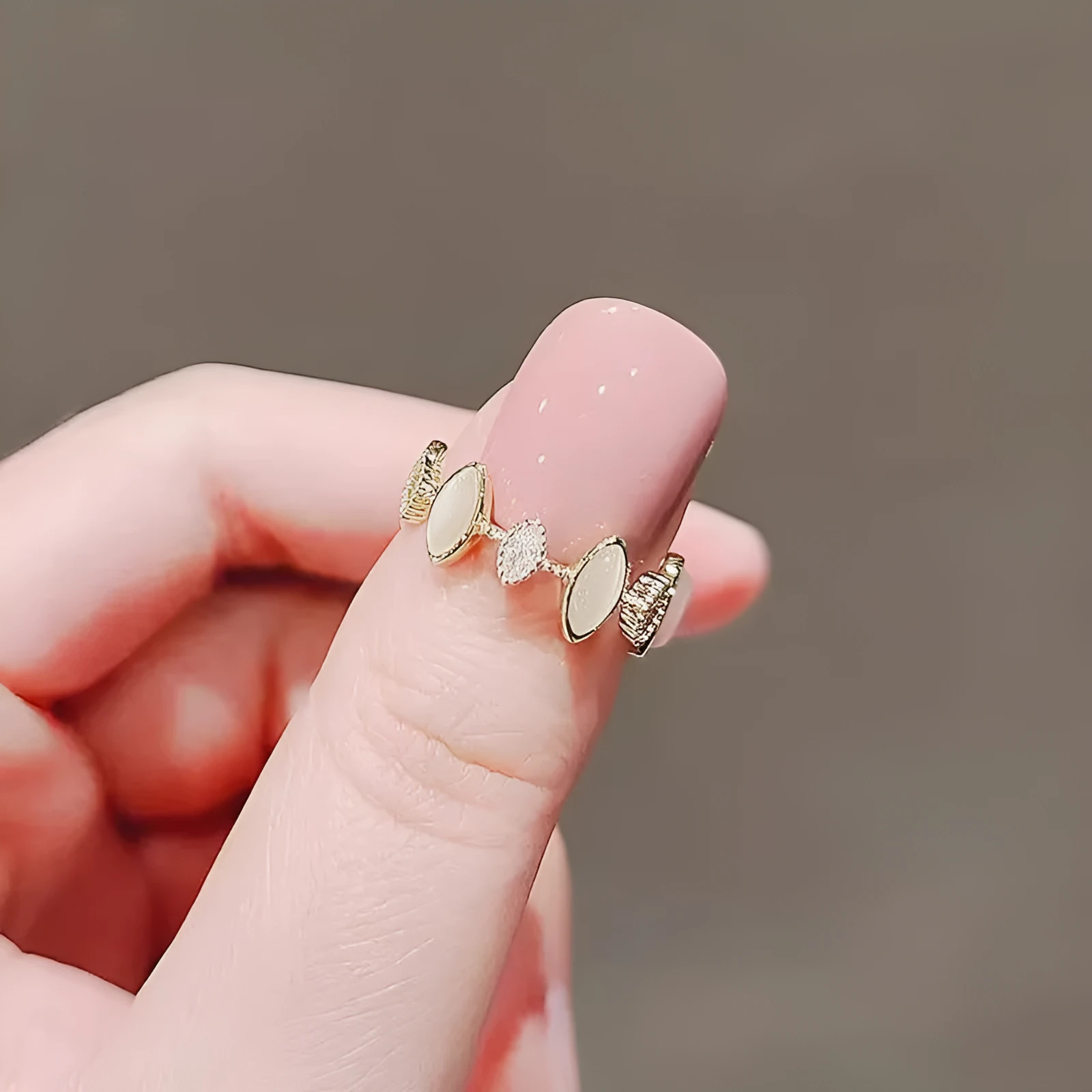 Copper geometric water drop ring for women with electroplated finish on white background