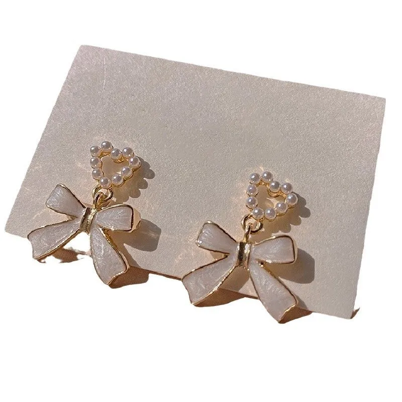 Gold-toned zinc alloy pearl bow drop earrings with electroplated finish, 2.4 by 1.9 cm