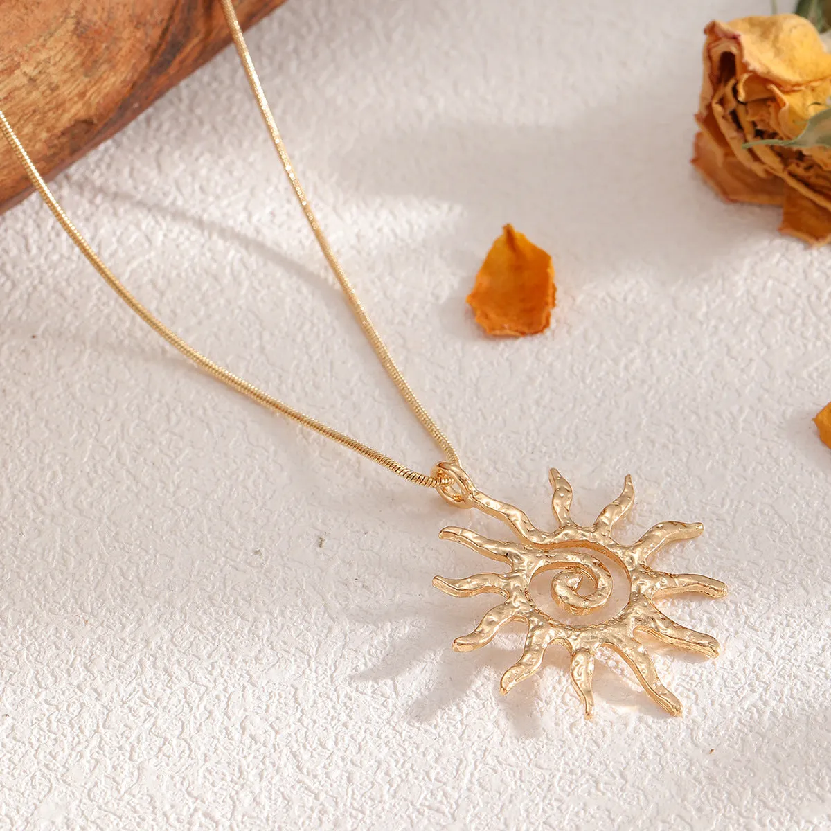 Gold sun hollow pendant necklace and earrings set with electroplated finish on zinc alloy