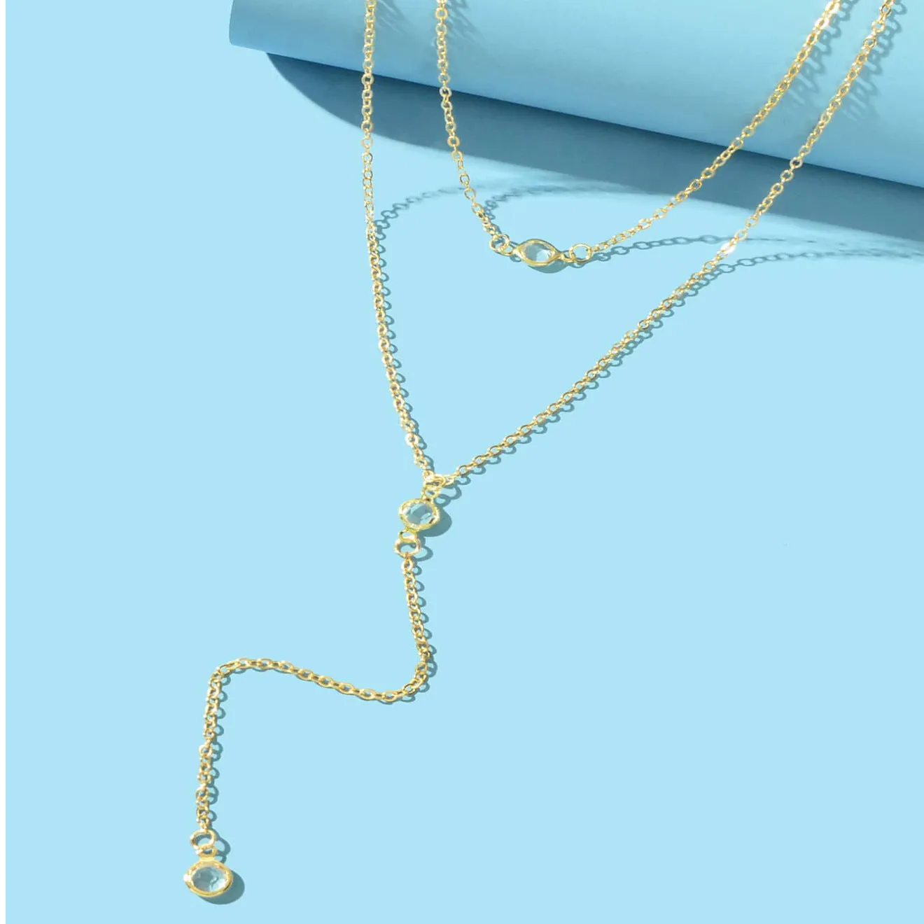 Alloy geometric pendant necklace with electroplated gold finish and O-ring chain on woman