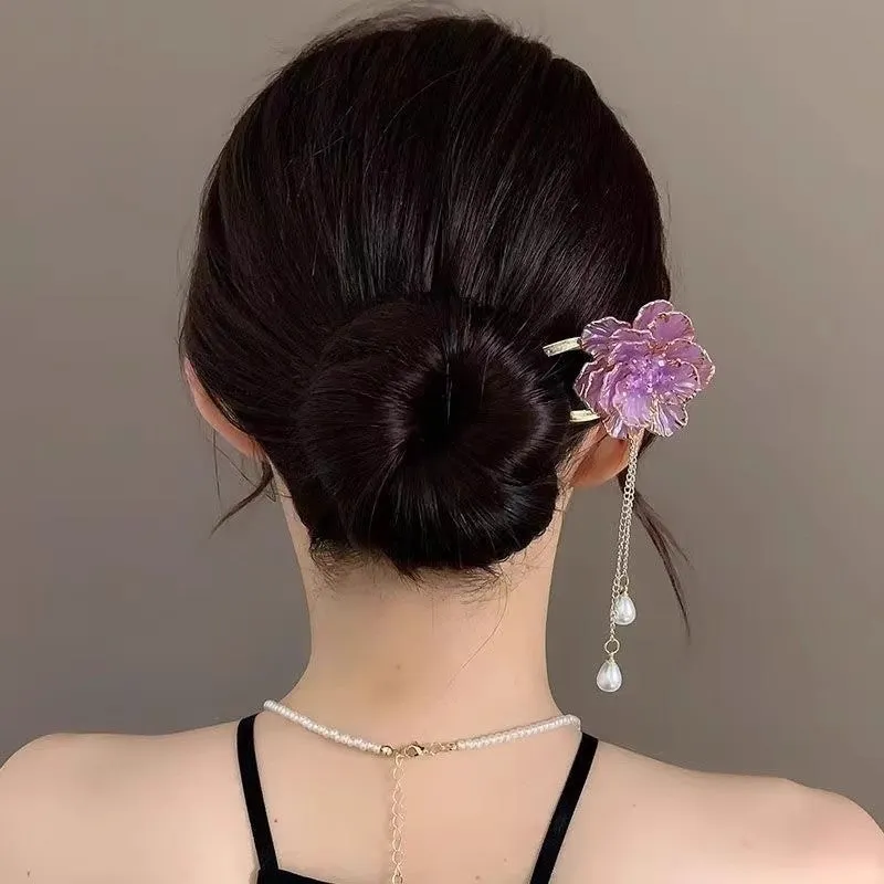 Close-up of a purple alloy U-shaped hairpin with a detailed peony flower and tassel design on a white background.