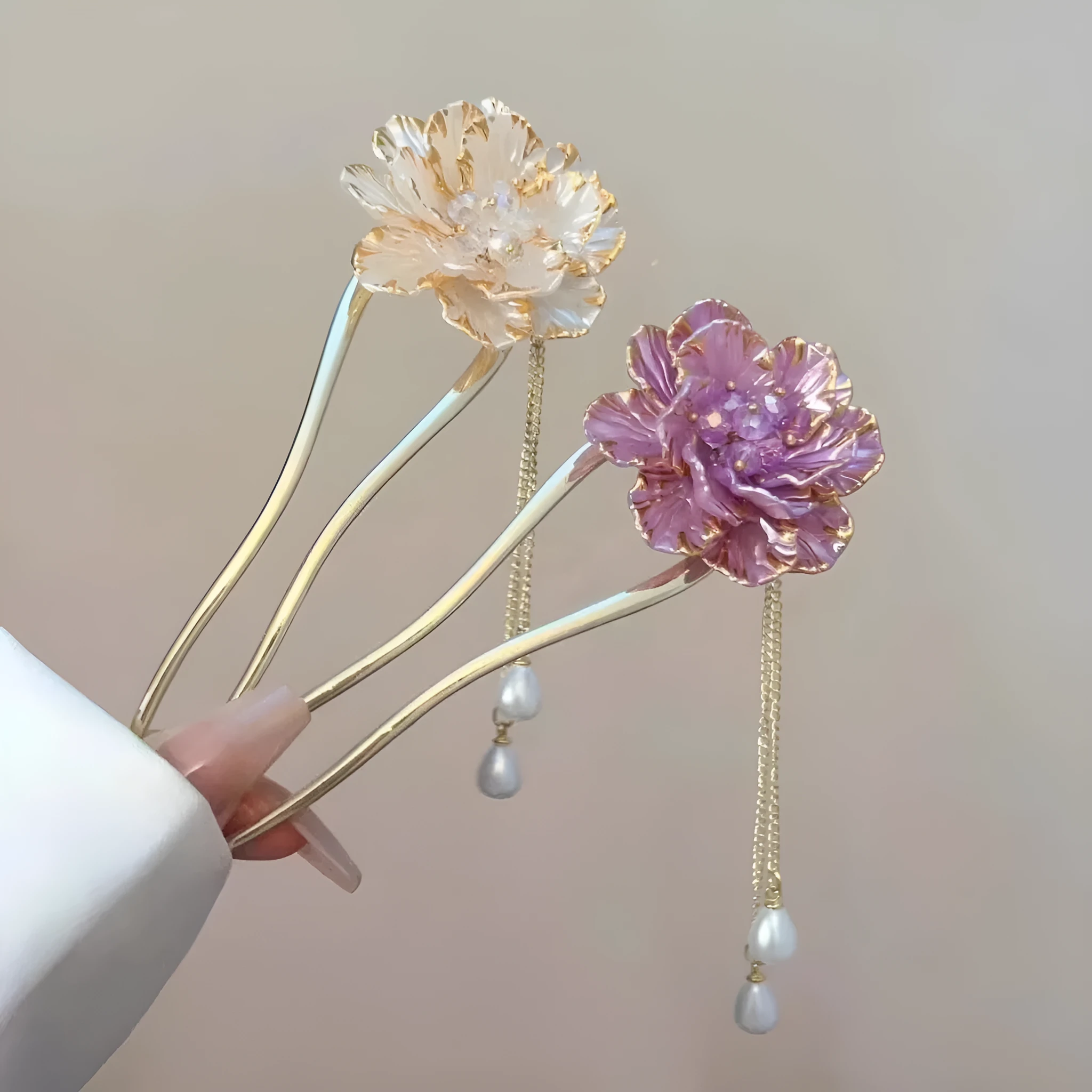 Close-up of a purple alloy U-shaped hairpin with a detailed peony flower and tassel design on a white background.