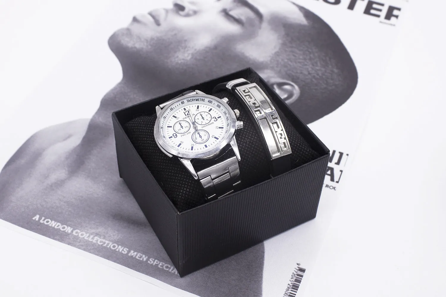 Men's quartz wrist watch set with round alloy dial, black face, and stainless steel buckle on a plain background