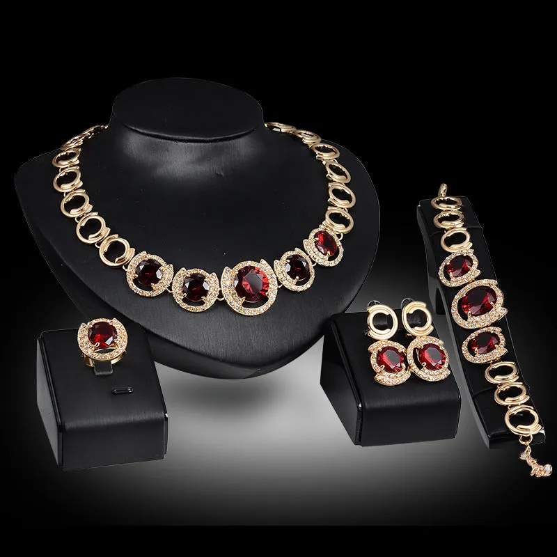 Gold-tone bridal jewellery set with crystal pendant necklace, earrings, ring, and bracelet with green red zircon stones