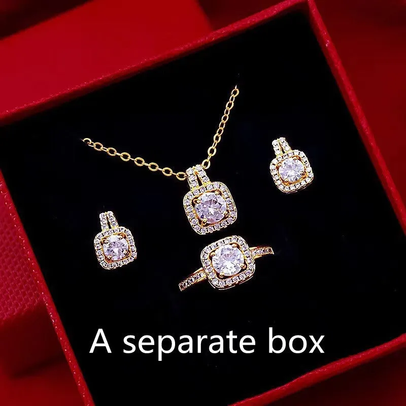 Gold-tone fashion jewellery set with zircon pendant necklace, stud earrings, and ring on white background