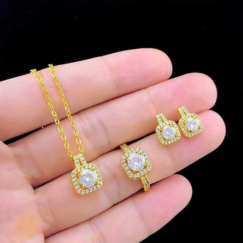 Gold-tone fashion jewellery set with zircon pendant necklace, stud earrings, and ring on white background