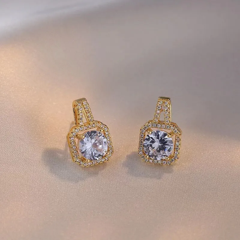 Gold-tone fashion jewellery set with zircon pendant necklace, stud earrings, and ring on white background