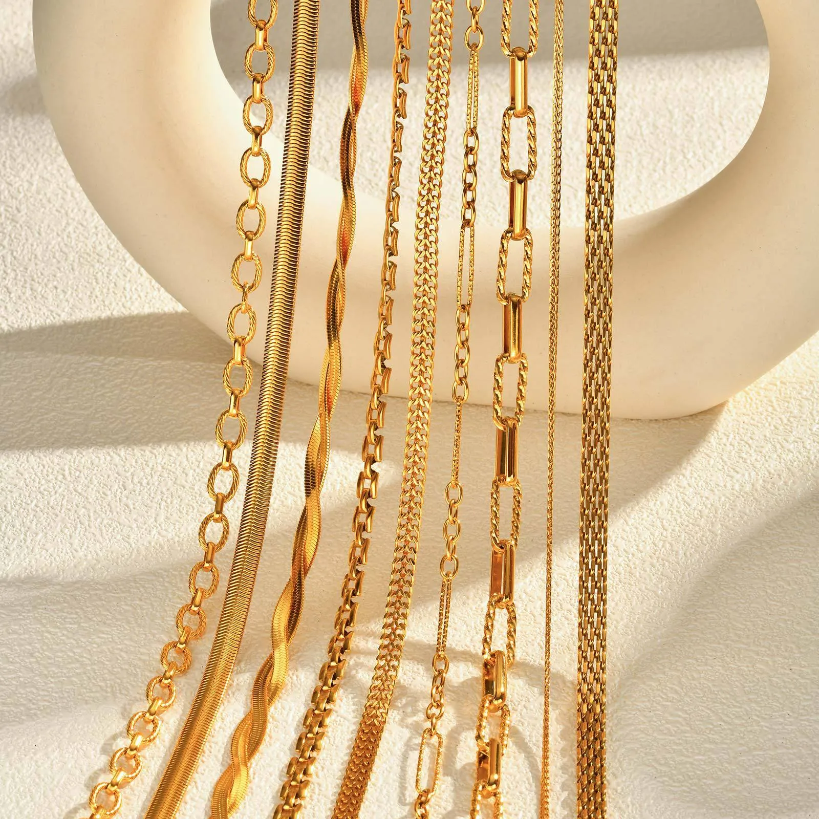 Stainless steel geometric twist necklace on snake bones chain, available in multiple colours