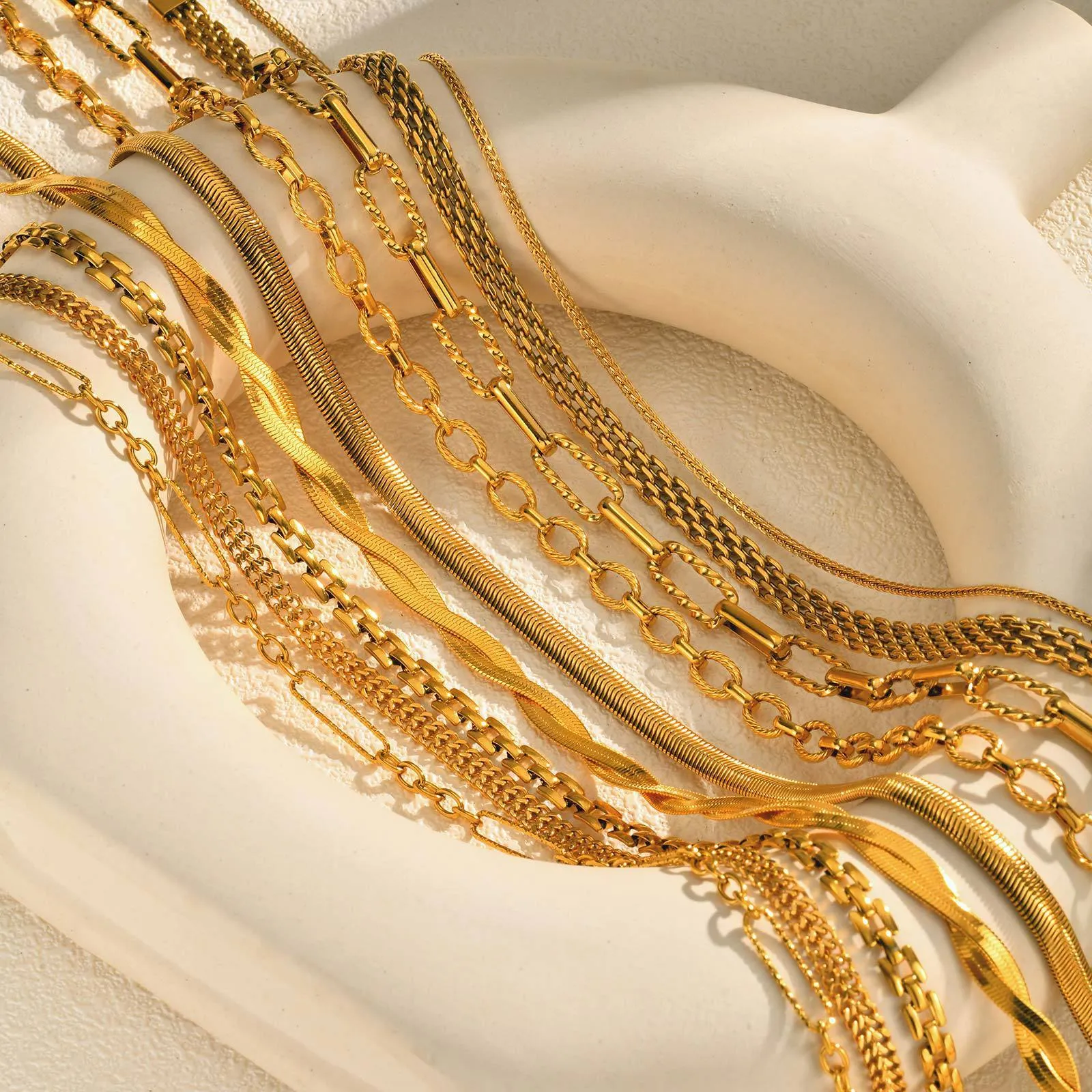 Stainless steel geometric twist necklace on snake bones chain, available in multiple colours