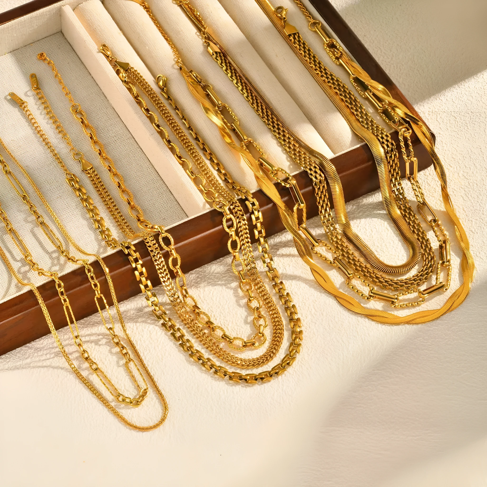 Stainless steel geometric twist necklace on snake bones chain, available in multiple colours