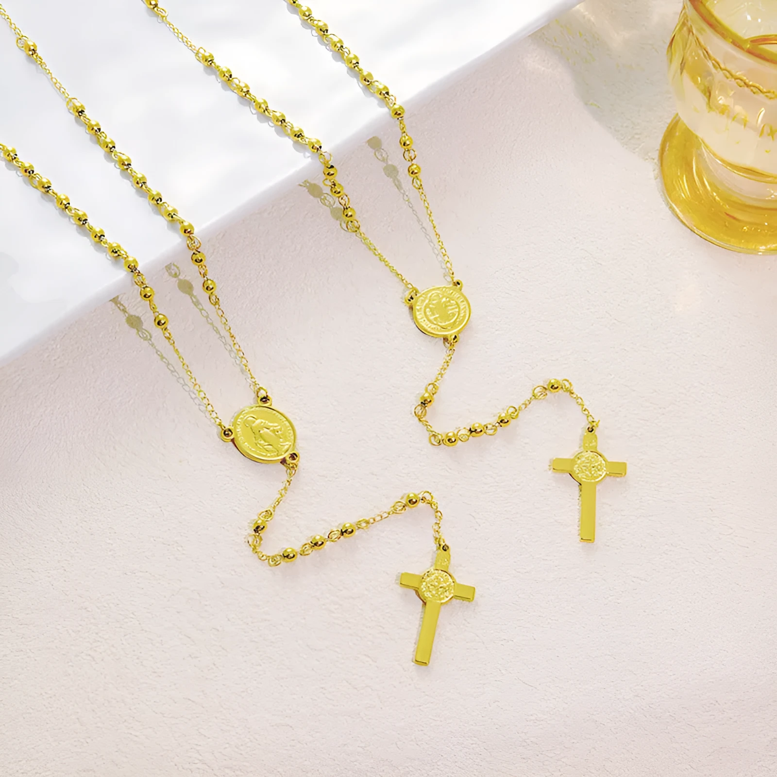 Stainless steel cross pendant necklace in golden colour with a priest pendant design on a simple chain