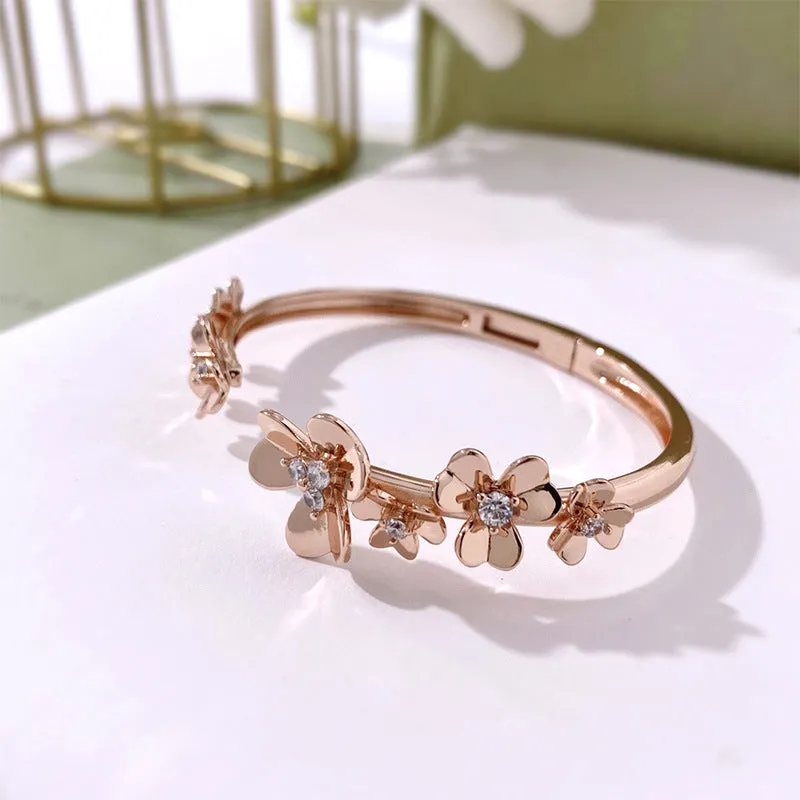 Three-leaf flower micro inlaid zircon bracelet in gold, rose gold, and silver colours on a copper base with electroplated finish.