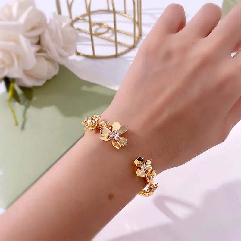 Three-leaf flower micro inlaid zircon bracelet in gold, rose gold, and silver colours on a copper base with electroplated finish.