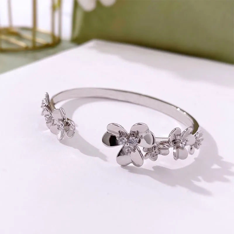 Three-leaf flower micro inlaid zircon bracelet in gold, rose gold, and silver colours on a copper base with electroplated finish.