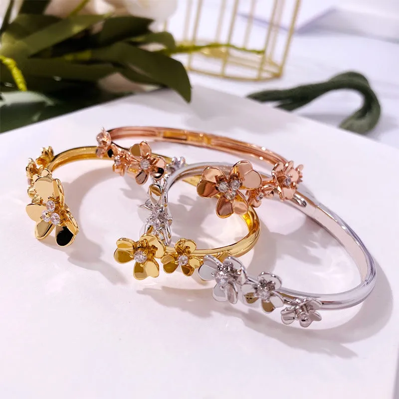 Three-leaf flower micro inlaid zircon bracelet in gold, rose gold, and silver colours on a copper base with electroplated finish.