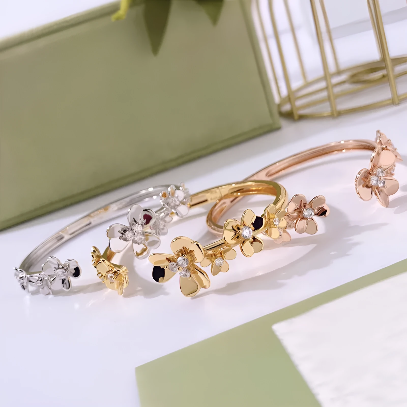 Three-leaf flower micro inlaid zircon bracelet in gold, rose gold, and silver colours on a copper base with electroplated finish.