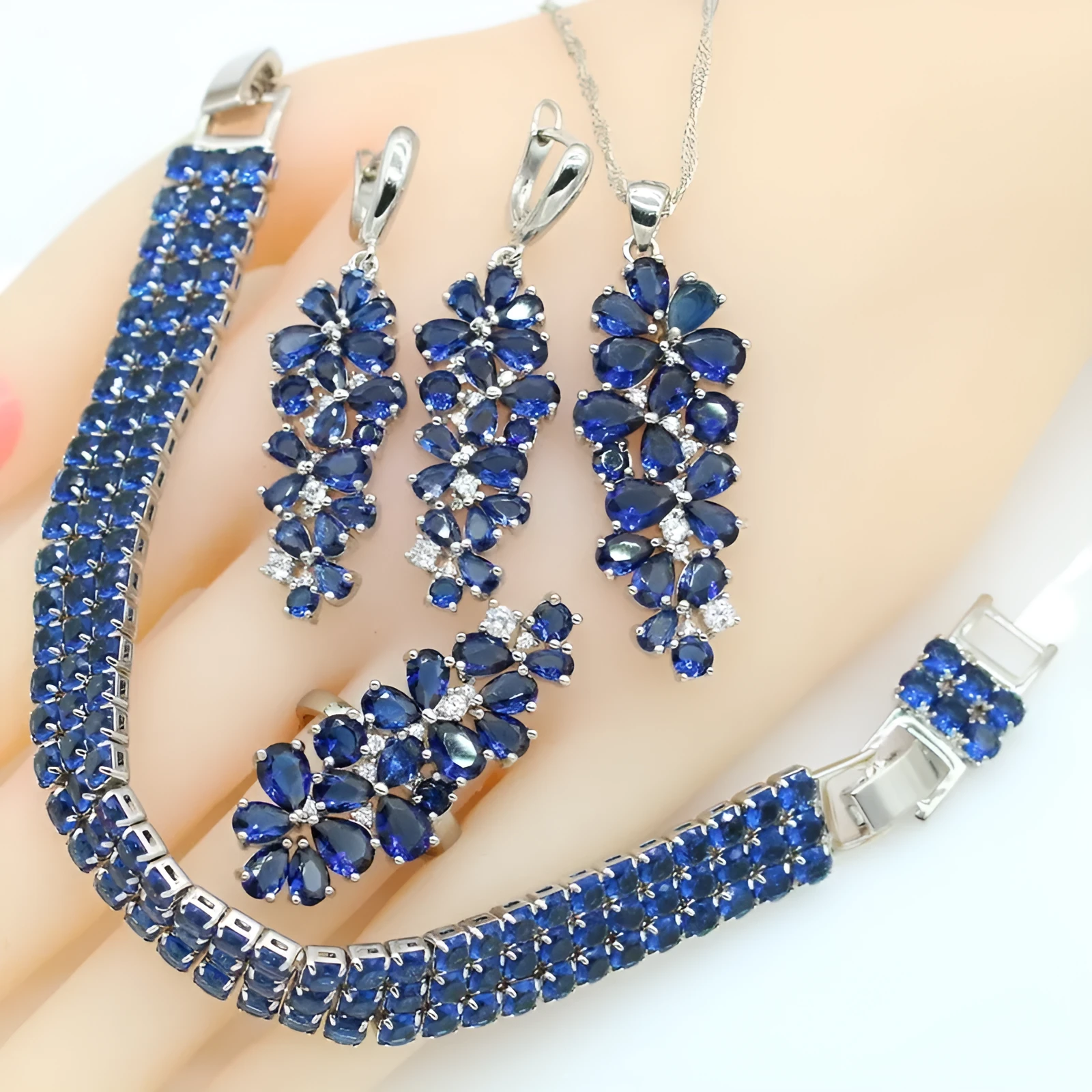 Dark blue copper inlaid zircon retro jewellery set including necklace, earrings, ring, and bracelet on display