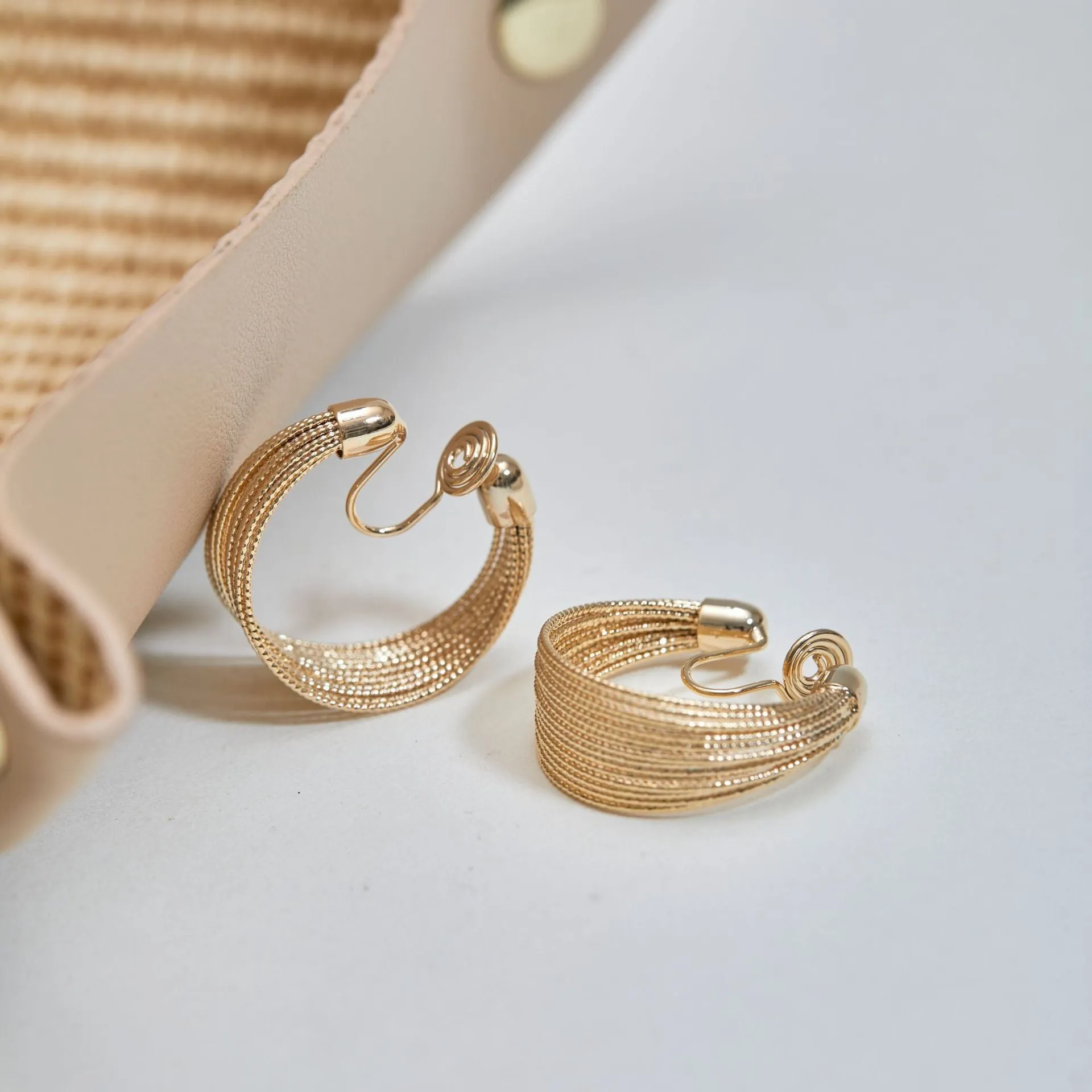 Geometric layered bracelet earrings with matching stud and clip earrings in gold or silver finishes