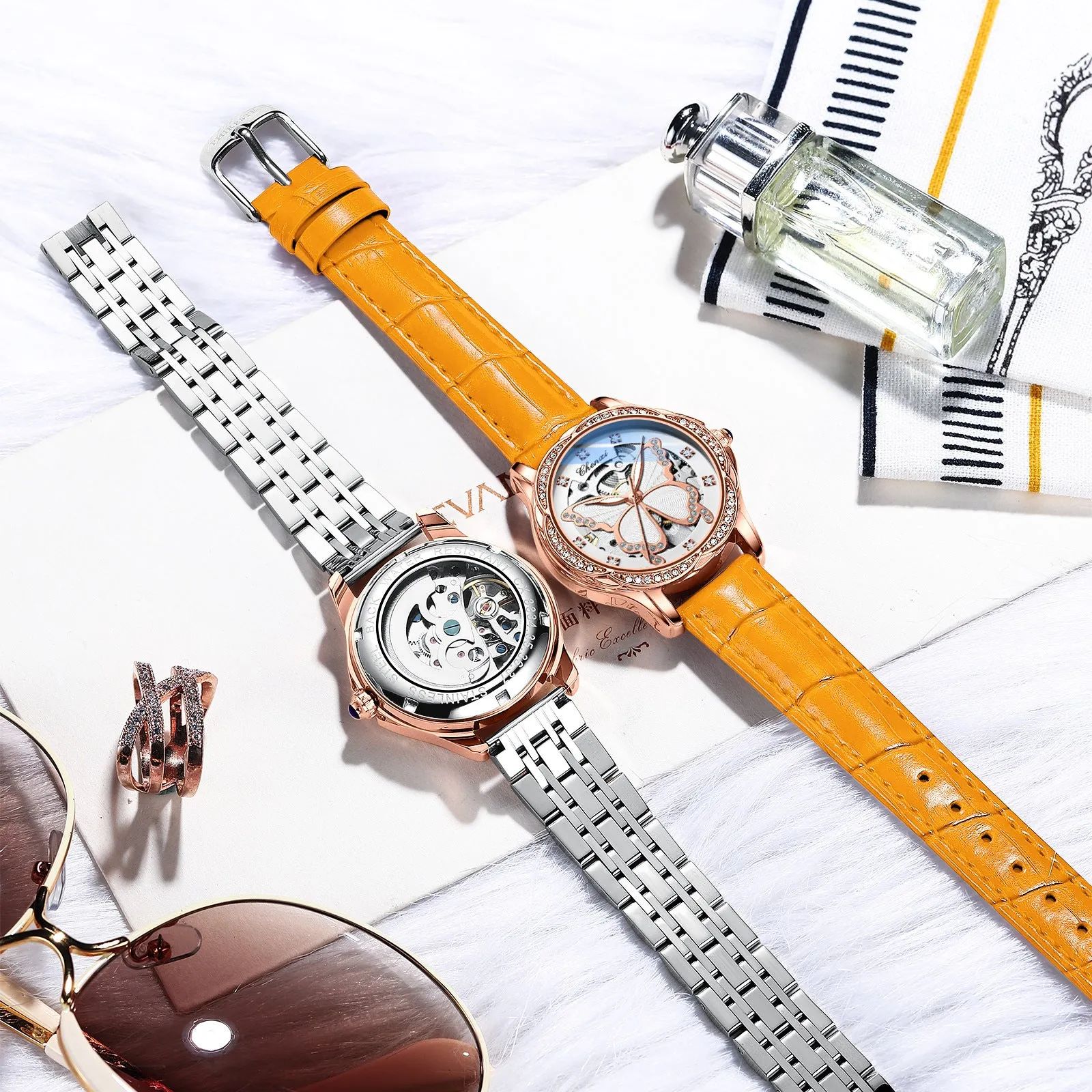 Butterfly dial diamond-embedded women's automatic mechanical watch with genuine leather strap and pin buckle on a white background