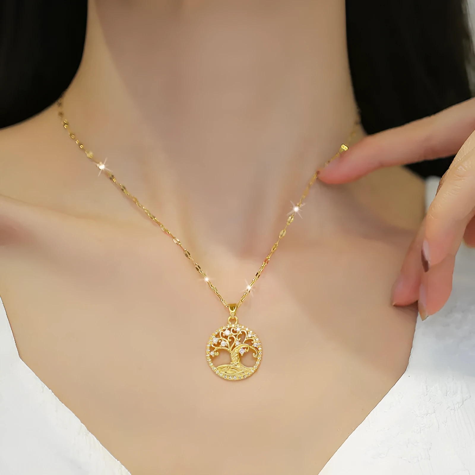 Gold-plated lucky tree pendant necklace with micro-inlaid rhinestones on an adjustable stainless steel chain.