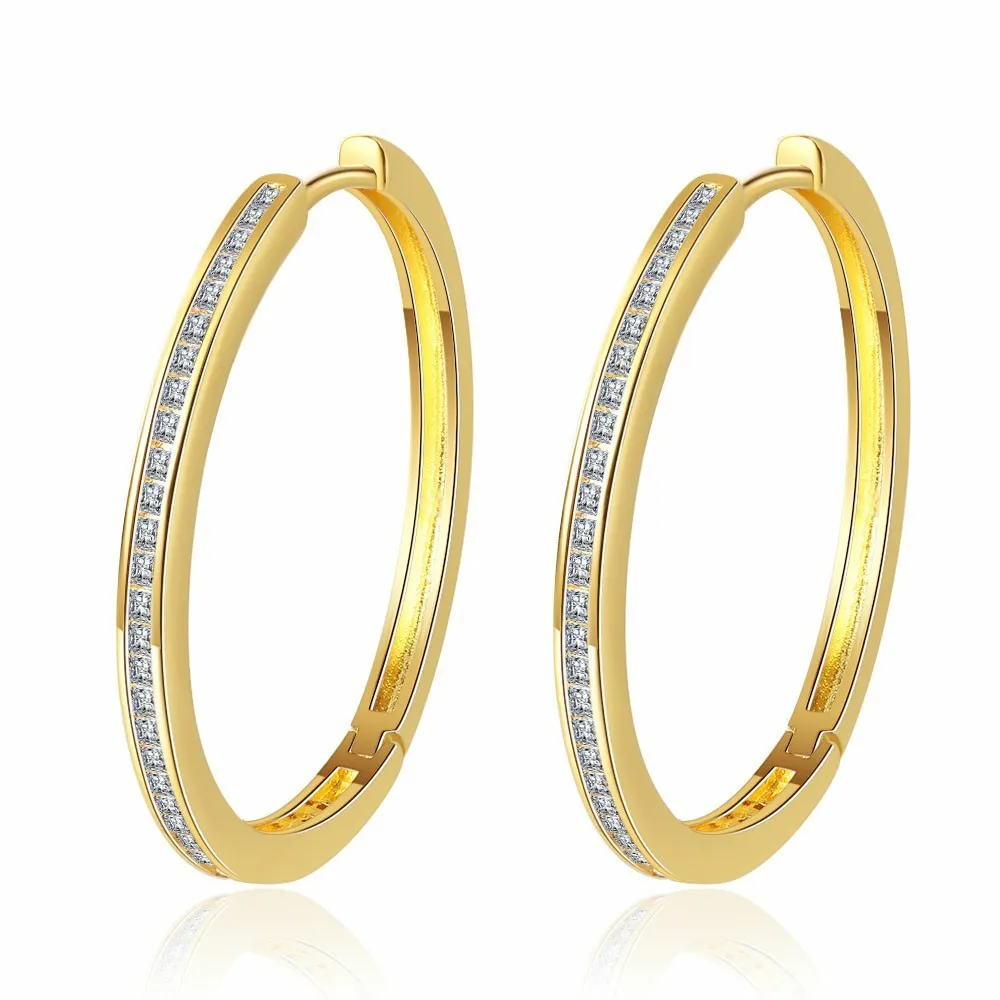 Gold-toned copper clip-on earring with round geometric shape and inlaid zircon stone