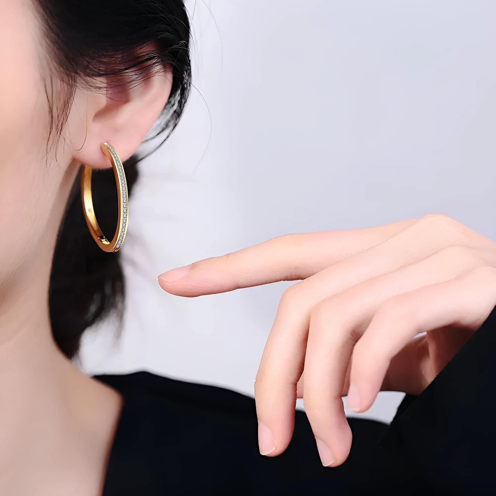 Gold-toned copper clip-on earring with round geometric shape and inlaid zircon stone