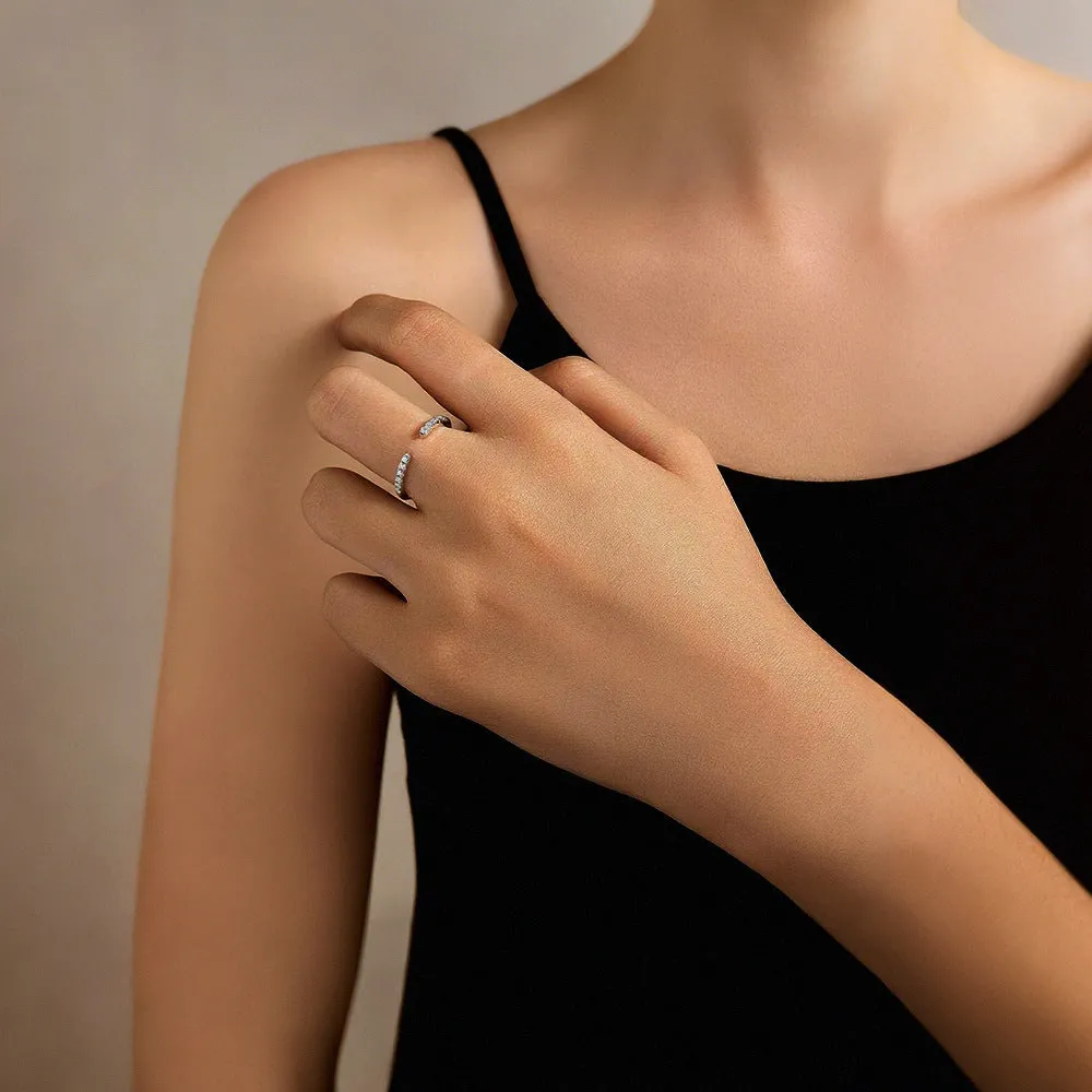 Silver adjustable opening ring with electroplated gold finish, geometric shape with round element on plain background