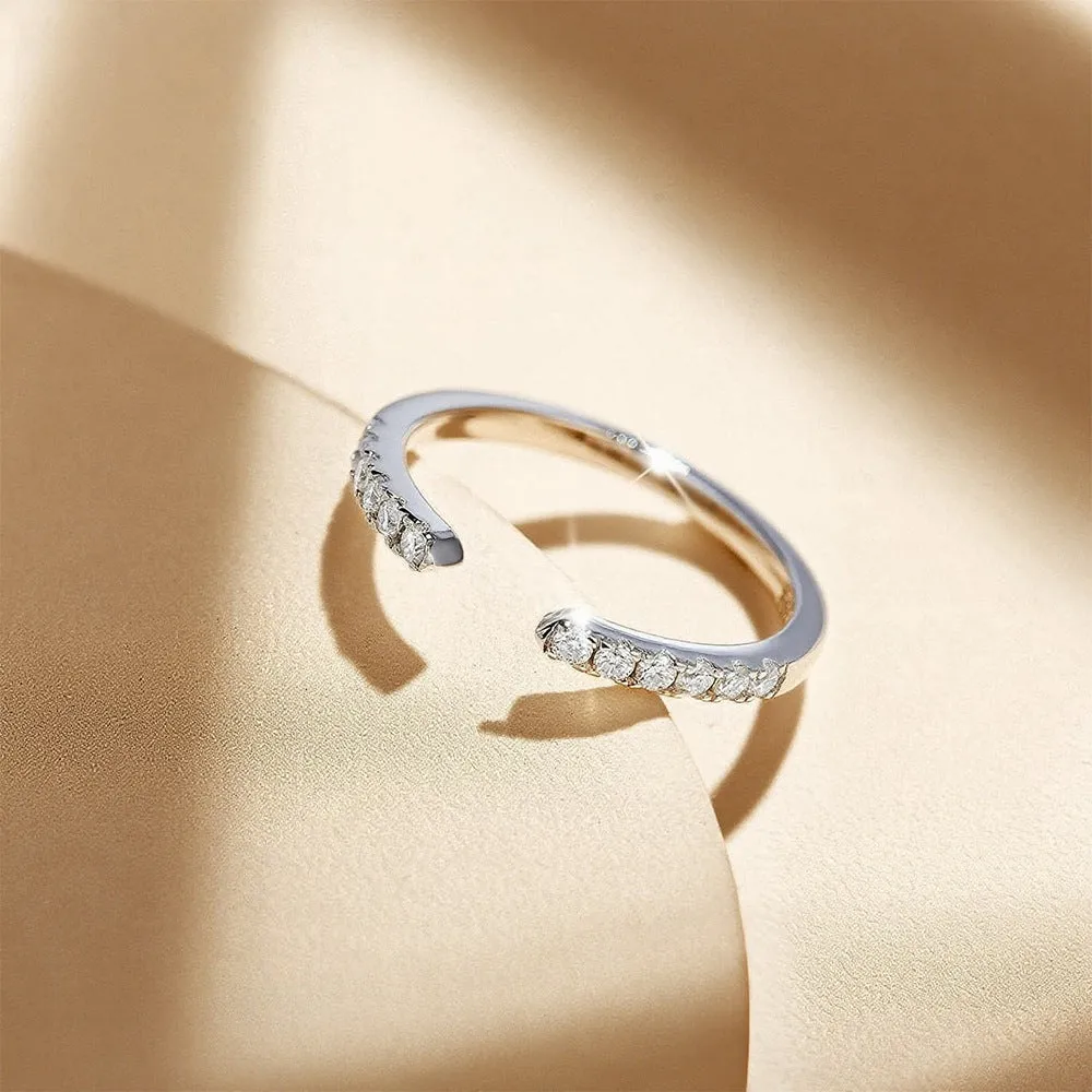 Silver adjustable opening ring with electroplated gold finish, geometric shape with round element on plain background