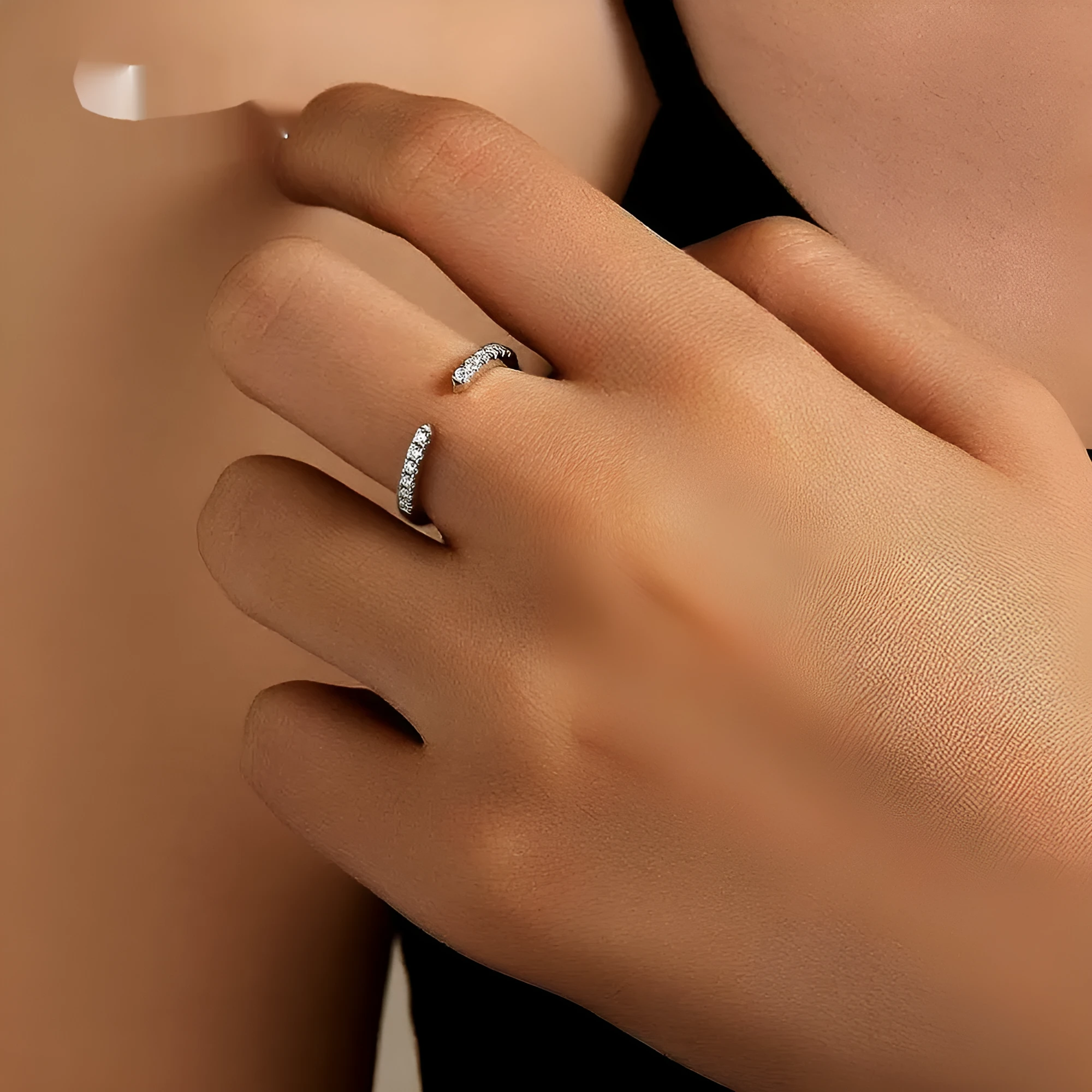 Silver adjustable opening ring with electroplated gold finish, geometric shape with round element on plain background