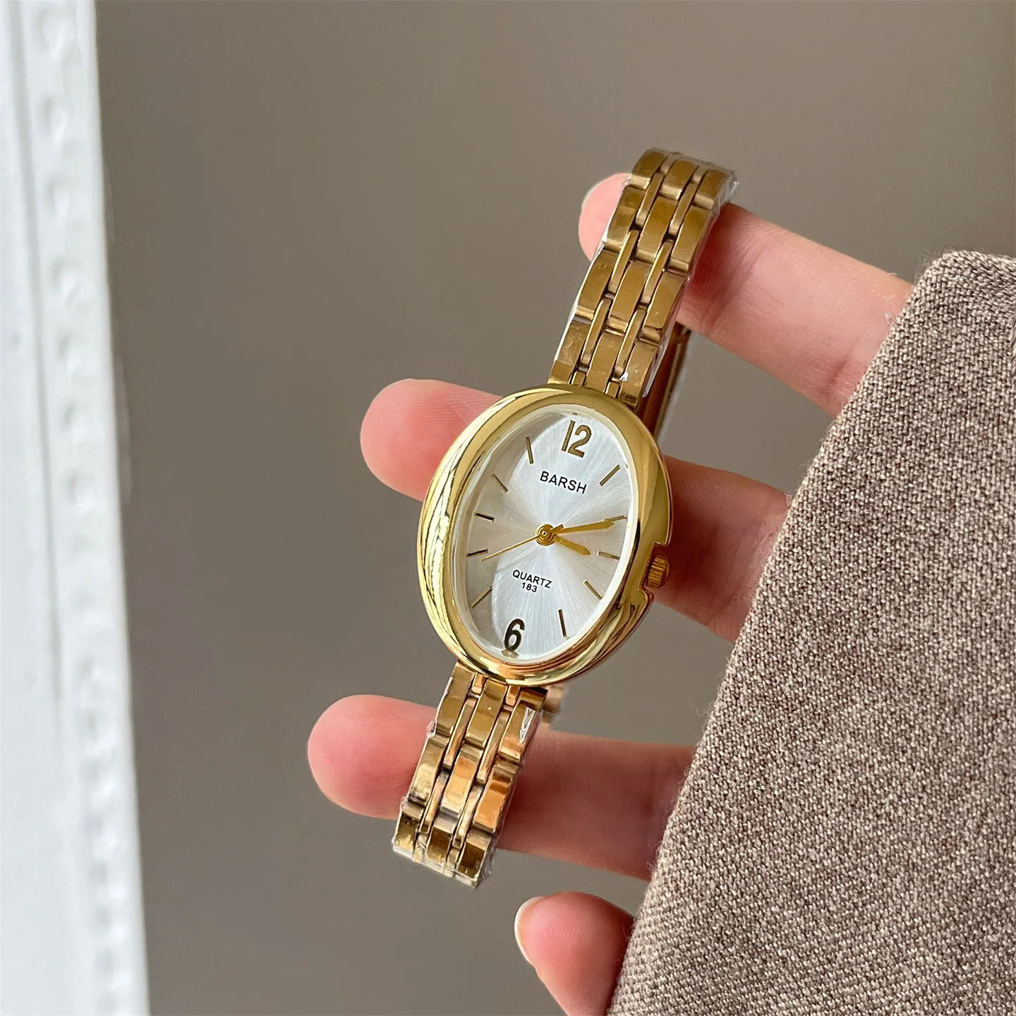 Oval alloy ladies watch with gold strap and choice of white gold or red dial face stainless steel back