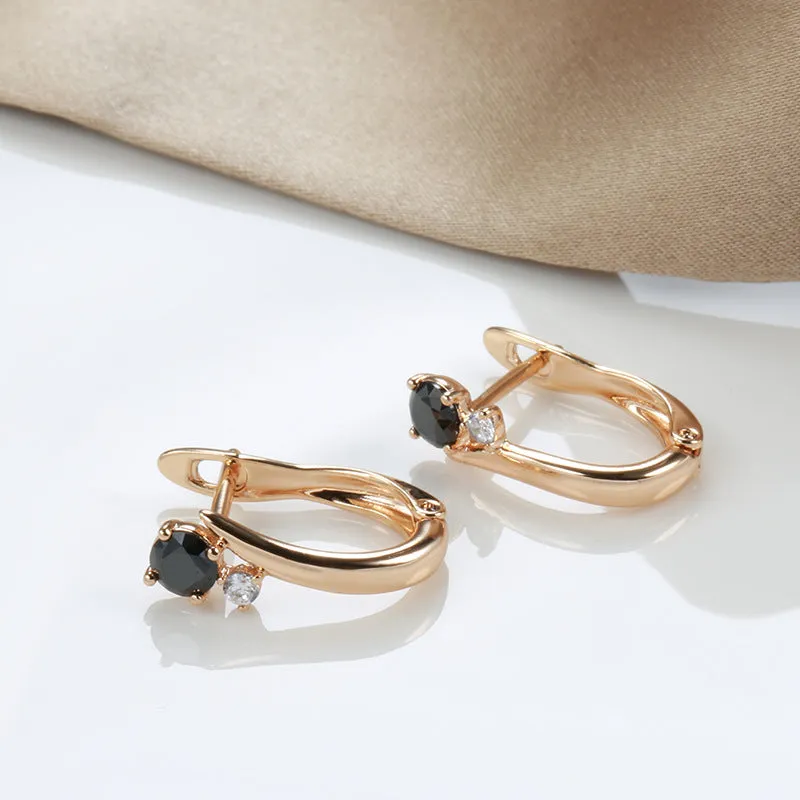 Gold-coloured drop earrings with geometric black agate design and retro styling
