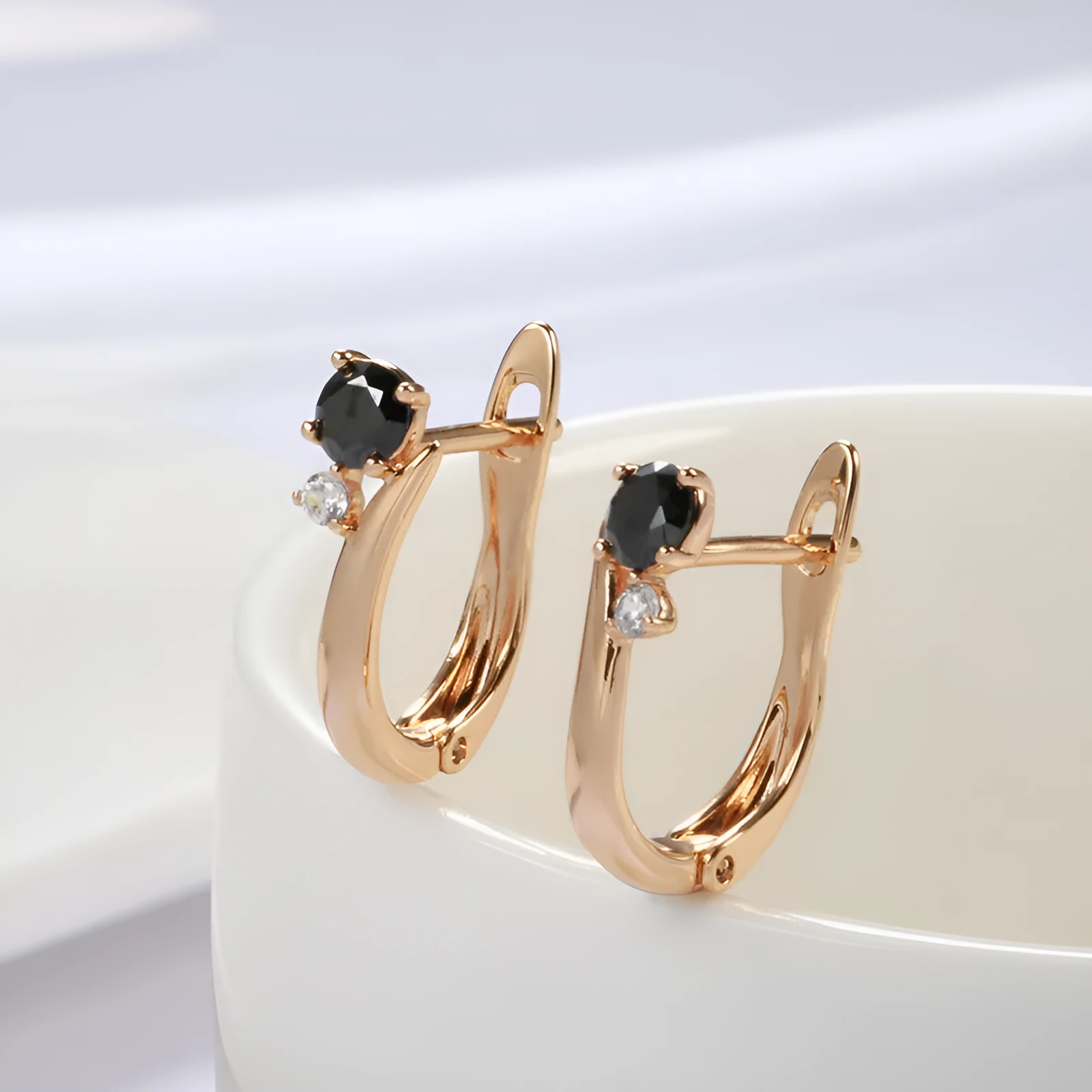 Gold-coloured drop earrings with geometric black agate design and retro styling