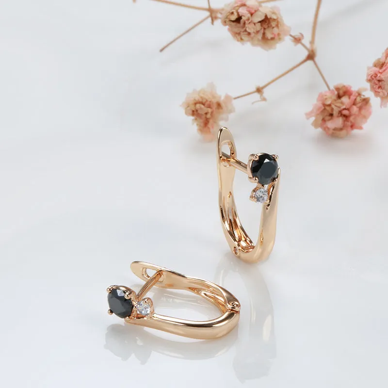 Gold-coloured drop earrings with geometric black agate design and retro styling