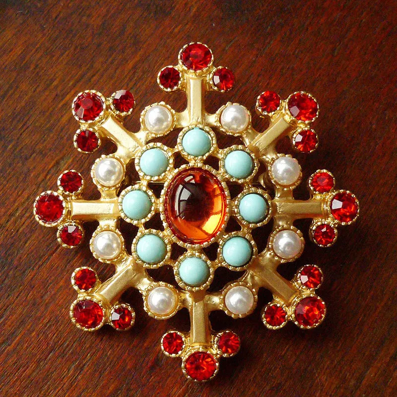 A selection of eight different zinc alloy retro baroque brooches in a diamond shape on a fabric background.