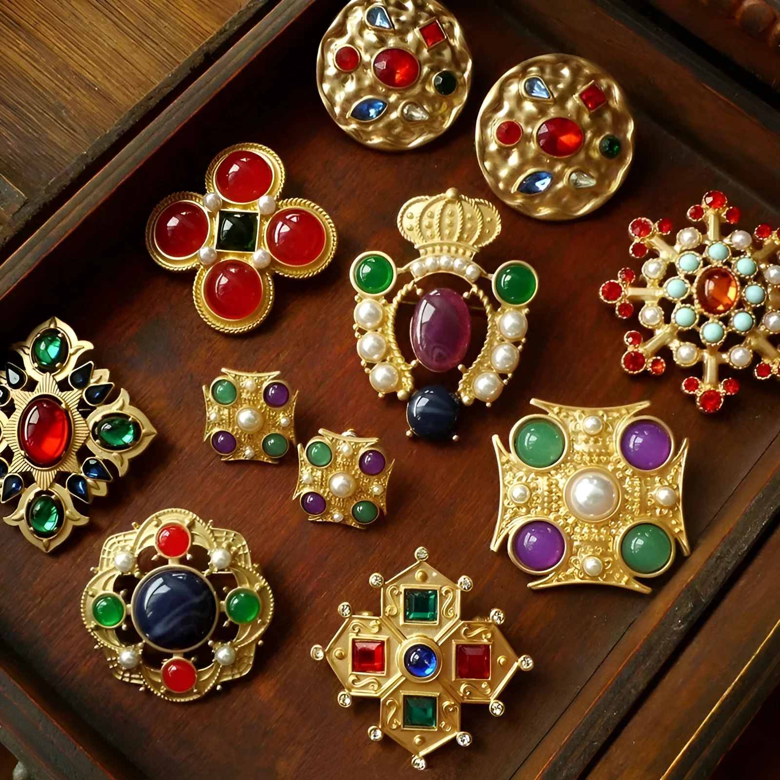 A selection of eight different zinc alloy retro baroque brooches in a diamond shape on a fabric background.