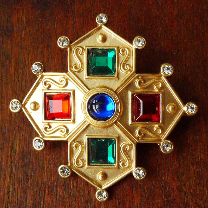 A selection of eight different zinc alloy retro baroque brooches in a diamond shape on a fabric background.