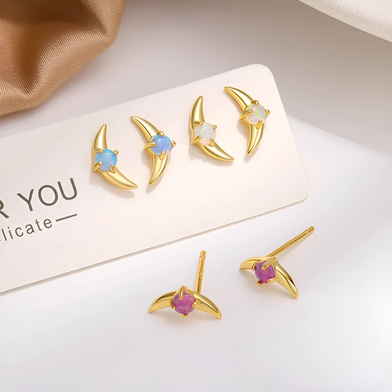 Women's geometric earrings in 925 silver with electroplated gold or platinum finish and coloured stone accents.