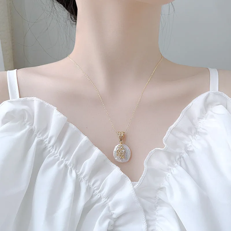 Women's matching baroque pearl geometry necklace with O-ring chain and earring set on display