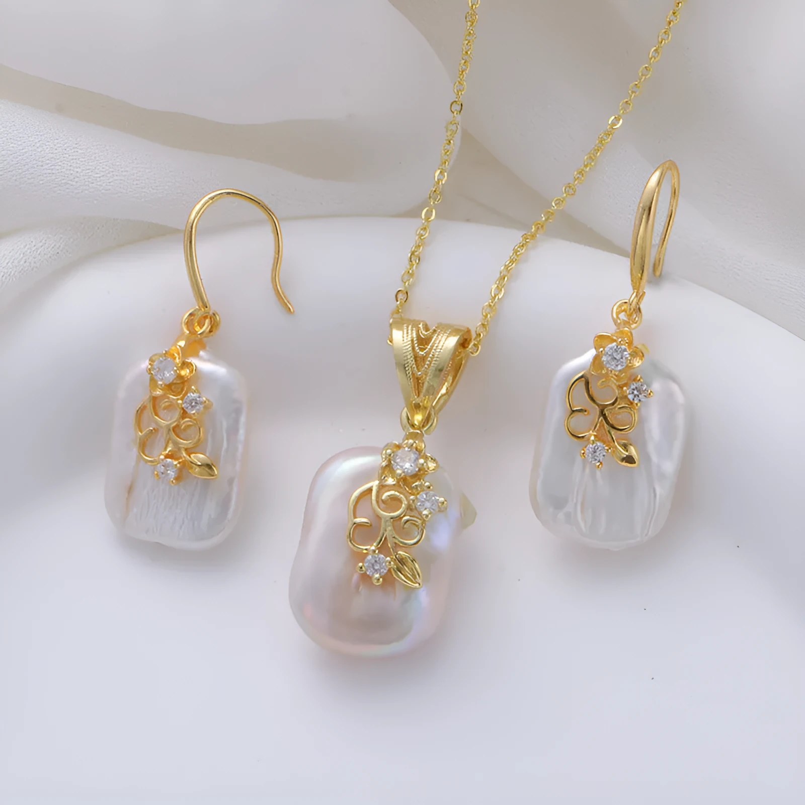 Women's matching baroque pearl geometry necklace with O-ring chain and earring set on display