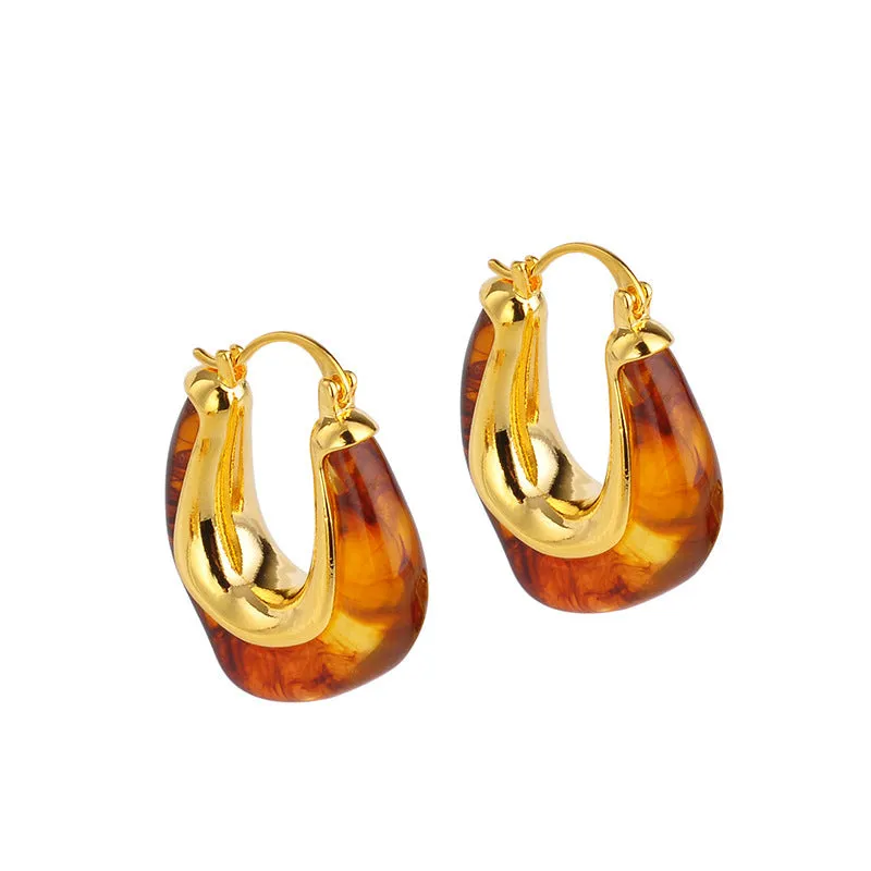 Copper geometry shape retro Maillard style earrings with electroplated finish in amber colour option on plain background